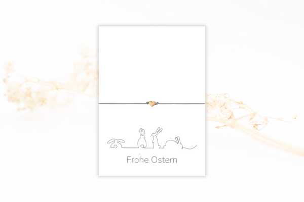 moderne weiße Frohe Ostern Karte mit Hasen Liniatur und mit grauem Armband mit Herz rosegold