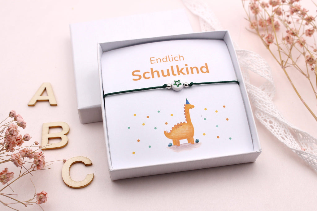Einschulungs Geschenkidee als kleiner Mutmacher für das Schulkind, Armband mit Dino Karte orange