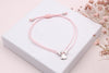 Zartes Schutzengel Armband aus rosa Makramee mit silberfarbenem Schutzengel in der Mitte