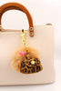 beiger Taschenanhänger mit Puschel und kleiner Mini Tasche im Leo design