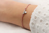 Schiebeknoten Armband mit Herz Anhänger und kleinen Perlen in silberfarben